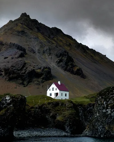 A white house on the rock cliffs of iceland