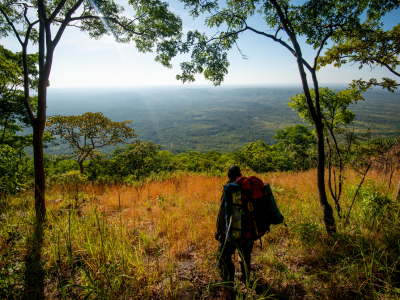 Man hiking in South Luangwa National Park, one of the best places to visit in Zambia