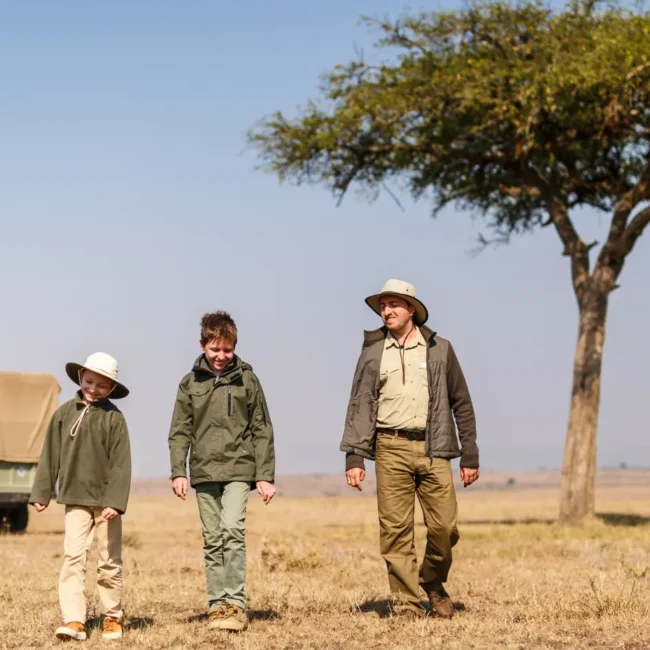 Family walking on a family safari in Africa