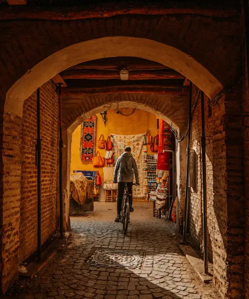 Man cycling through Marrakesh, one of the best places to visit in Morocco
