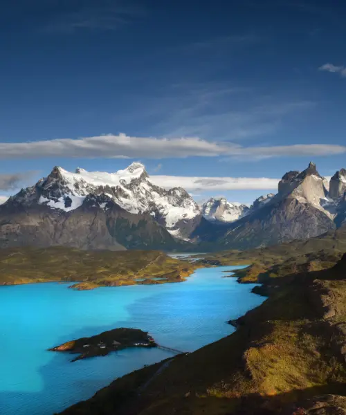 Glacial lake between snow capped mountains in Patagonia