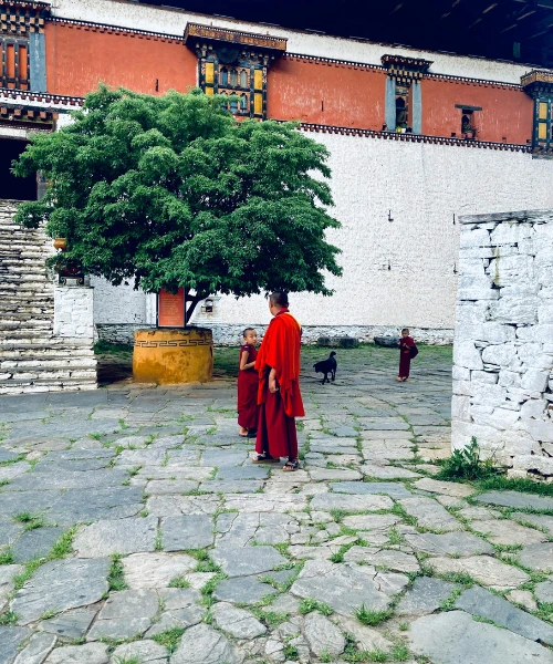 Monk and child in a courtyard in Bhutan