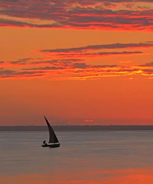 Boat sailing at sunset in Mozambique
